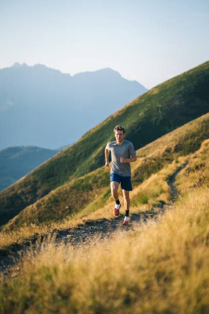 istock Trail runner bounds along mountain trail 1690850951