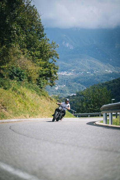 istock Motorcyclist rides mountain road 1690851895