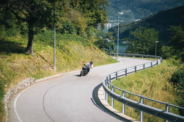 istock Motorcyclist rides mountain road 1690852036