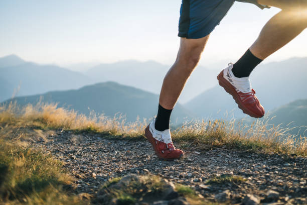 istock Trail runner bounds along mountain trail 1690854866