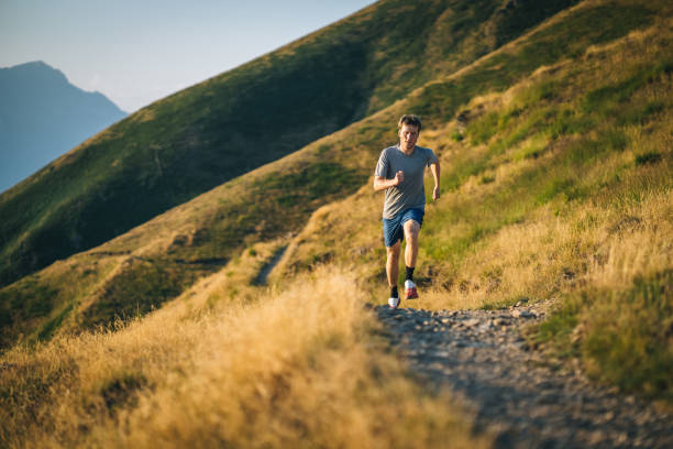 istock Trail runner bounds along mountain trail 1690854868