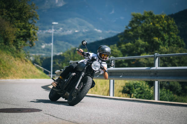 istock Motorcyclist rides mountain road 1690856536
