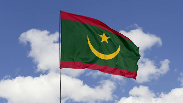 mauritania Flag is Waving Against in the Sky. 3d illustration flag of mauritania. mauritania flag isolated on the blue sky. mauritania flag waving stock pictures, royalty-free photos & images