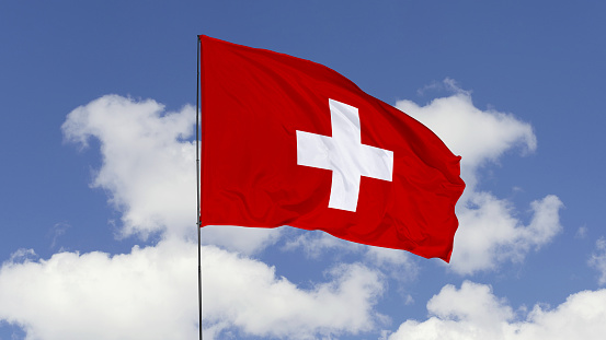 3d illustration flag of Switzerland. Switzerland flag isolated on the blue sky.