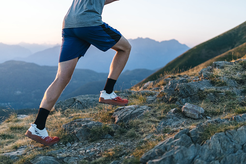 Low angle view of runner at sunrise, Ticino Canton