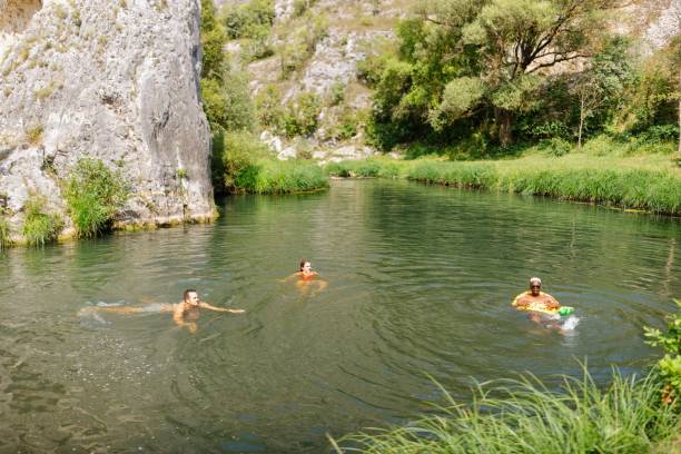 istock Joyful people swimming and relaxing in the water 1690862165