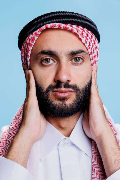 istock Man in muslim headscarf covering ears 1690866631