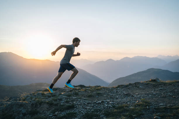 istock Trail runner bounds along mountain trail 1690868897