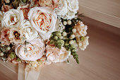 Wedding bouquet of roses on wooden background