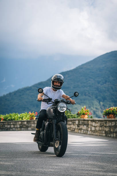 istock Motorcyclist rides mountain road 1690873312