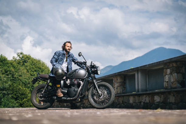 Retro style motorcycle with sunset sky background.