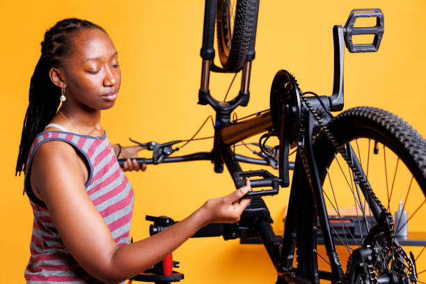 istock Female cyclist inspects damaged bicycle 1690878972