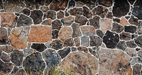 Lava basalt stone wall on a historic building.