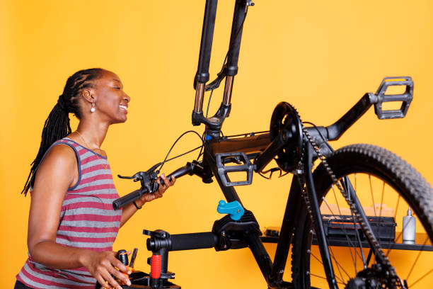 istock Woman engrossed in fixing bicycle parts 1690890263