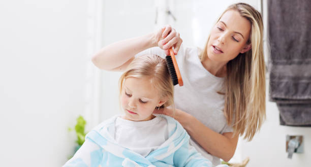 Morning, mother and daughter in bathroom with hair brush for grooming care routine in family home. Motherhood, child and mama brushing hair of young kid in house and getting ready for the day. Morning, mother and daughter in bathroom with hair brush for grooming care routine in family home. Motherhood, child and mama brushing hair of young kid in house and getting ready for the day. human hair women brushing beauty stock pictures, royalty-free photos & images