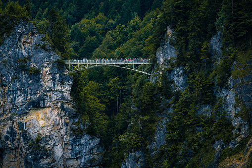 View of Marienbrücke on a rainy autumn day. Mountain slopes and rocks covered with forest.
