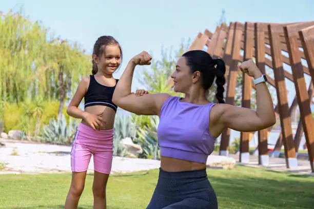 Photo of Sporty mom and daughter being active outdoors.