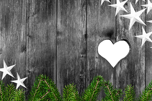 Heart in wooden background and fir branches