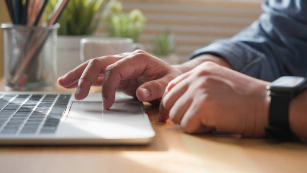 istock Close-up of man hands using and typing keyboard of laptop computer on office desk. Workspace, businessman working project creative idea for job online network. Business finance and technology concept. 1690919260
