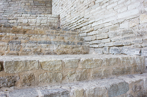 Old stone steps. Dilapidated steps made of block and stone. Vintage stone staircase.