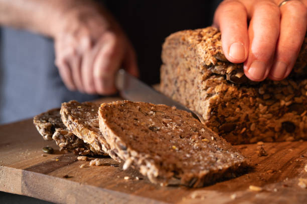 istock Cutting fresh whole wheat bread into slices 1690922245
