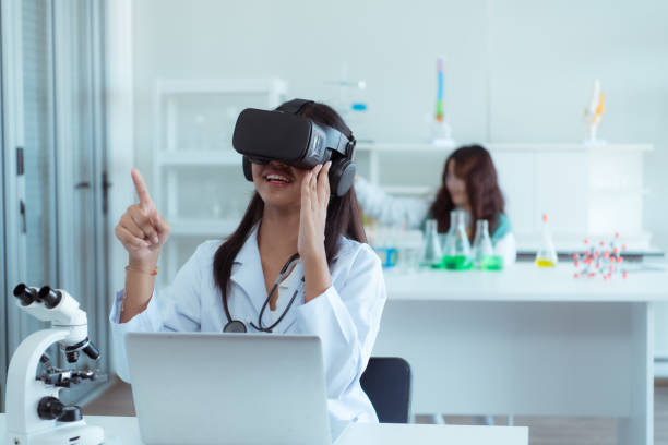 istock Girl scientist using virtual reality headset while colleagues working in background at laboratory 1690923368