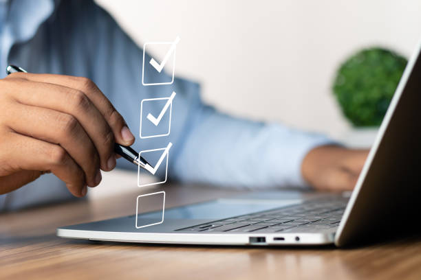 istock Digital Checklists for efficient business management, Businessman touching marking on checklist guide to paperless assessment and Future Success, Streamlining operations with online surveys. 1690924612