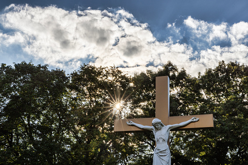 A big concrete cross in the field near Rila mountain.