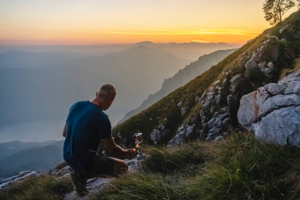 istock Hiker preparing coffee in the high mountains during sunrise 1690931922