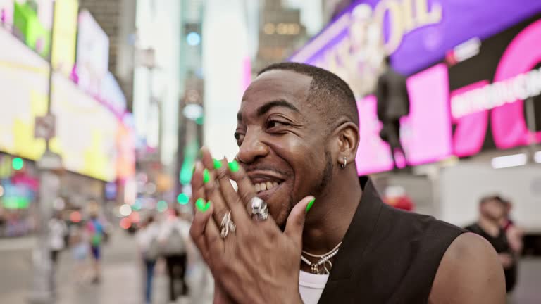 Candid headshot of laughing Black man on Broadway