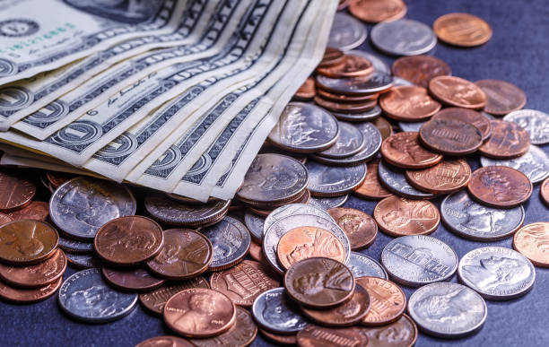 istock American coins and us dollars on a black table 1690933914