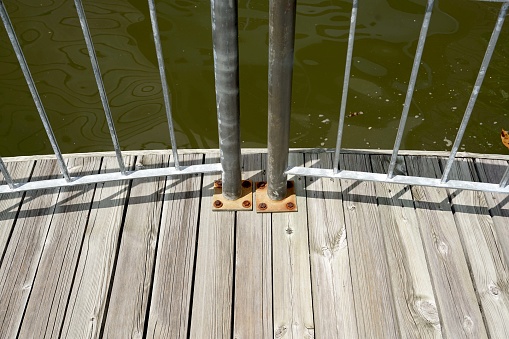 Wooden footpath over green lake. Aerial view.