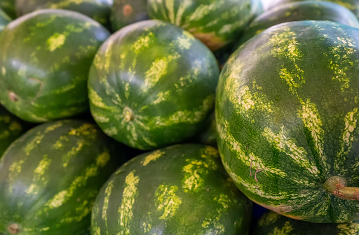 Lots of watermelons in the city market.