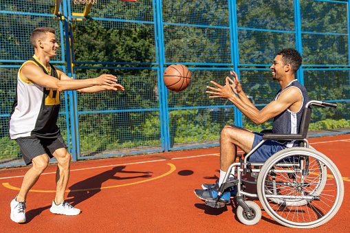 disabled sport men in action while playing indoor basketball at a basketball court