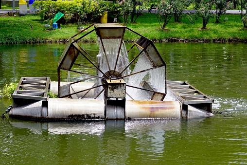 Close up a waterwheel on the pond in the park.