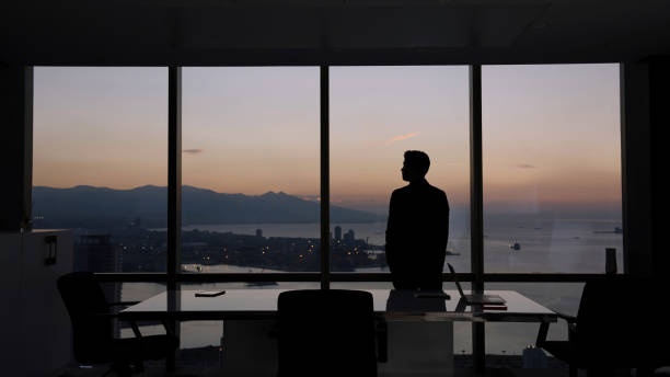 Businessman standing in modern office stock photo