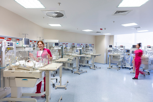 Babies and nurse in a special baby care unit.
Newborn. special care. Intensive care department. Babies in the incubator.