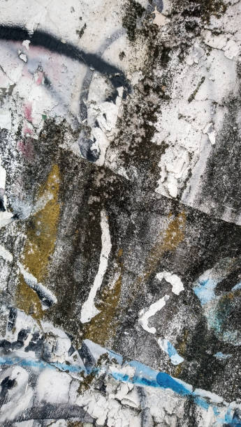 istock Grunge Old Weathered Concrete Wall With Cracked Peeled Multiple White Black Gray Olive Green Purple And Blue Paint Layers High Resolution Background Texture Stock Photo 1690941259
