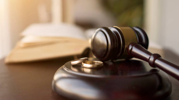istock Judge gavel and wedding rings for divorce proceedings. 1690941655