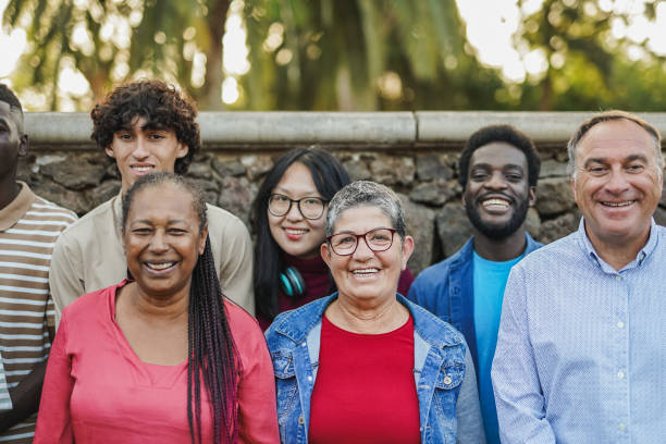 istock Multiracial people with different ages smiling on camera at city park - Community, inclusion and multiracial friends concept 1690944896