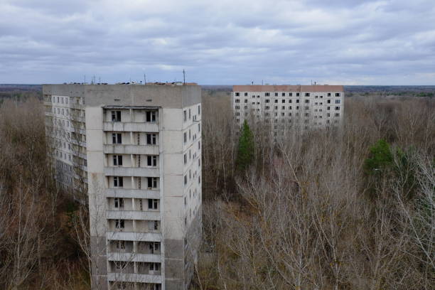 istock Abandoned panel houses among leafless trees in Pripyat. Beautiful cloudy sky over the city. Post-Soviet architecture. 1690944909