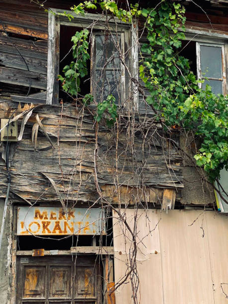istock Old house with broken windows and a sign with the inscription 1690945414