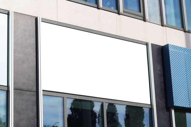 istock Large black billboard banner on a storefront mockup. Blank white restaurant or shop sign mock up and copy space template. 1690945693