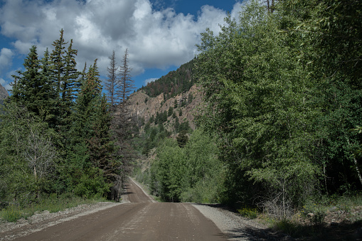 Dirt road through the Colorado San Juan mountains in southwestern USA of North America. Nearby cities are Lake City, Durango, Ouray,Telluride, Denver, and Colorado Springs, Colorado