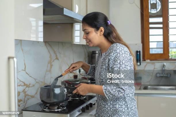 Woman Cooking In Kitchen At Home Stock Photo - Download Image Now - Adult, Adults Only, Apartment