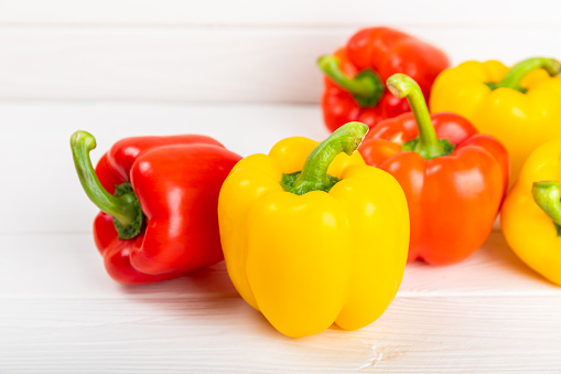 Fresh colorful red and yellow bell peppers on background. Bell pepper. Vegetables. Vegan food. Healthy foods. Place for text. Place to copy. Diet concept.
