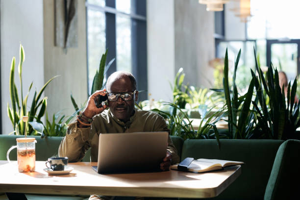 istock Senior man talking on the phone in cafe 1690962300