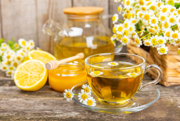 istock Chamomile tea in cup on  texture background. Natural hour with chamomile flowers. Herbal tea. Immunity tea.Natural healer concept. Healthy detox drink.Close up. Place for text. 1690962512