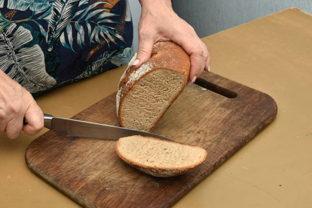 istock The housewife cuts round bread with a knife. 1690971159
