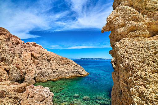 Majestic rocks of Greek island landscape. Sunny summer day, beautiful sky, limestone cliffs, ideal vacation location, tourist destination. Firopotamos beach, Milos island, Greece.